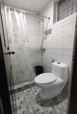 a bathroom with a toilet and a shower at SULIT CONDO Unit 2 Santa Mesa Manila in Manila