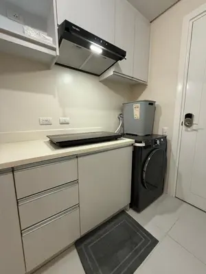 a small kitchen with a stove and a washer at Studio penthouse 1 in Manila