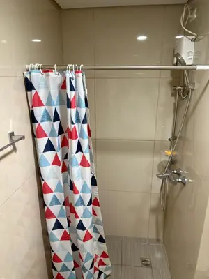a shower curtain with a red white and blue pattern at Studio penthouse 1 in Manila