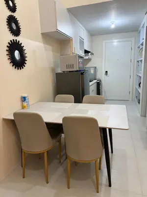 a kitchen and dining room with a table and chairs at Studio penthouse 1 in Manila