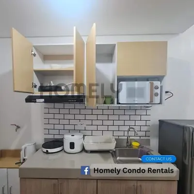 a kitchen with a sink and a microwave at Homely - SMDC Green 2 Residences, Dasmarinas City in Pasong Bayog
