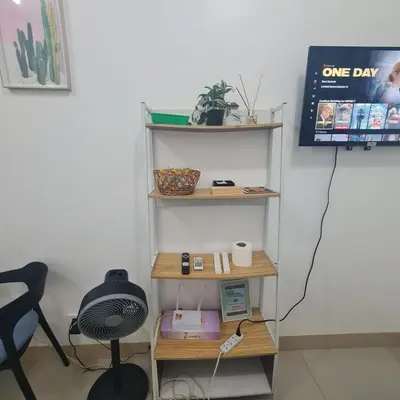 a shelf in a room with a desk and a chair at Homely - SMDC Green 2 Residences, Dasmarinas City in Pasong Bayog