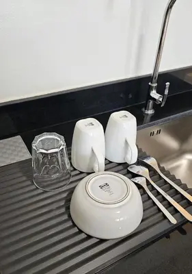a kitchen counter with two white appliances on a counter top at Fabulous View Circulo Verde, Manila QC in Manila