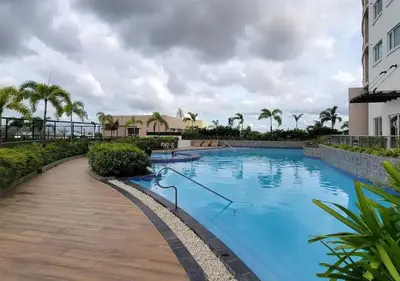 a swimming pool at a resort with palm trees at Fabulous View Circulo Verde, Manila QC in Manila