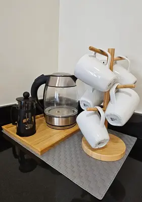 a coffee maker on a wooden tray with a coffee pot at Fabulous View Circulo Verde, Manila QC in Manila