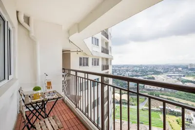 a balcony with a view of the city at Modern Comfort Your Gateway to Quezon City One Free Parking in Manila