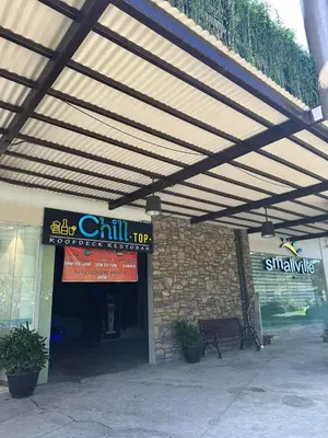 awning over a building with a bench in front at Modern Comfort Your Gateway to Quezon City One Free Parking in Manila