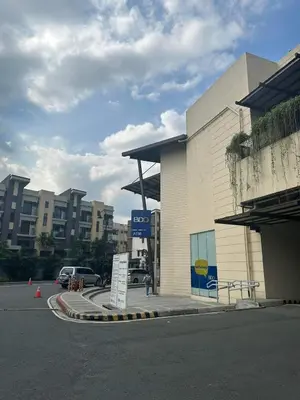 a gas station with a sign in a parking lot at Modern Comfort Your Gateway to Quezon City One Free Parking in Manila