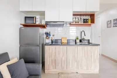 a kitchen with a counter and a refrigerator at Modern Comfort Your Gateway to Quezon City One Free Parking in Manila