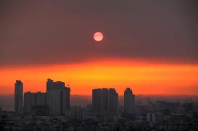 a sunset over a city with the sun in the sky at The Milano Residences by Versace Stylish 1BR Condo in Manila