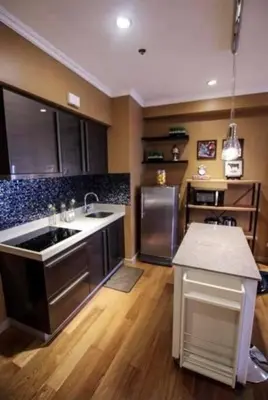 a large kitchen with a sink and a refrigerator at The Milano Residences by Versace Stylish 1BR Condo in Manila