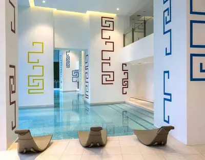 a lobby with two chairs and a swimming pool at The Milano Residences by Versace Stylish 1BR Condo in Manila