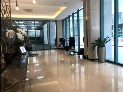 a lobby of a building with a hallway with windows at One Uptown Residence 1Br 2Bed Affordable for 4,Uptown Mall Linked in Manila