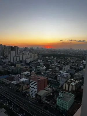 a view of a city with the sunset in the background at AMAZING VIEWS ACROSS SHANGRILA MALL and NEAR MEGAMALL GREENFIELD DISTRICT in Manila