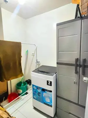 a kitchen with a small refrigerator next to a cabinet at Spacious 3BR Condo at Little Baguio Terraces San Juan City in Manila