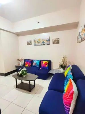 a living room with blue couches and a table at Spacious 3BR Condo at Little Baguio Terraces San Juan City in Manila