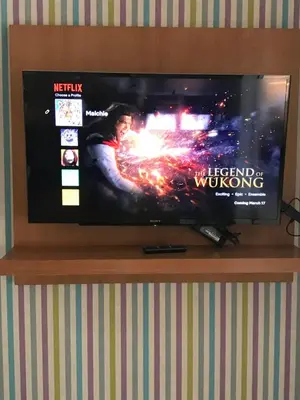 a flat screen tv sitting on top of a shelf at One Bedroom with Netflix at Legaspi Village Makati in Manila