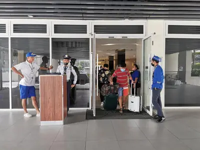 a group of people standing outside of a building at Sunshine at Grace nr BGC in Manila