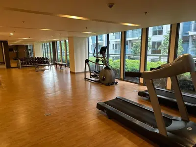 a gym with treadmill and exercise equipment in a building at NAIA Terminal 3 Insane Interior, Be the Boss in Manila