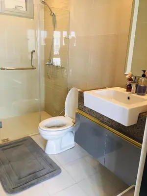a bathroom with a toilet and a sink and a shower at NAIA Terminal 3 Insane Interior, Be the Boss in Manila