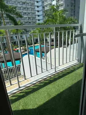 a balcony with a view of a swimming pool at 331D Near MOA and Airport Pool View Fast WiFi Balcony in Manila
