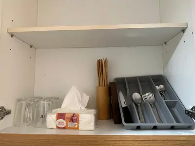 a kitchen counter with utensils on a shelf at 331D Near MOA and Airport Pool View Fast WiFi Balcony in Manila