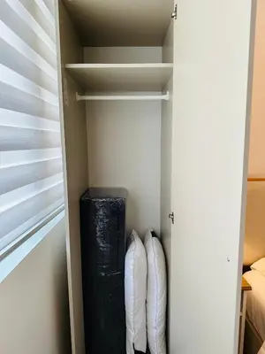 a walk in closet with two white towels at 331D Near MOA and Airport Pool View Fast WiFi Balcony in Manila