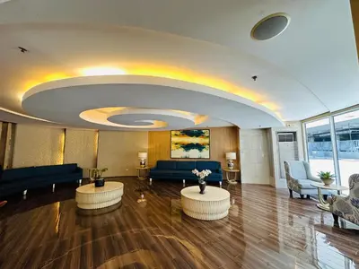 a lobby with couches and tables in a building at 331D Near MOA and Airport Pool View Fast WiFi Balcony in Manila