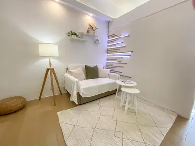 a living room with a white couch and a table at nJoy! CHIC & Luxury at Venice Grand Canal in Manila