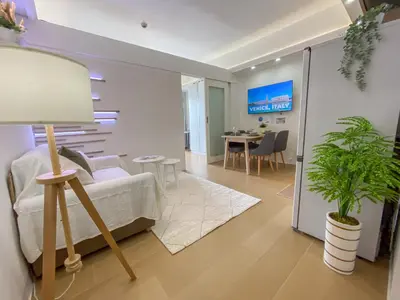 a living room with a couch and a table at nJoy! CHIC & Luxury at Venice Grand Canal in Manila