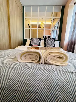 a large bed with a large blanket on it at 5th One Bedroom Condo in Grace Residences Taguig in Manila