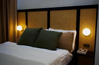 a bedroom with a bed with two lamps on it at NUVALI Amaia Steps Parkway 2 BR Condo THE SANCTUARY with pool, free parking near Carmelray Industrial Park, Ayala Solenad, Xavier School in Pitland