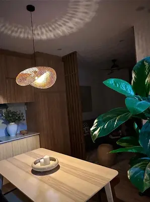 a dining room table with a lamp and a plant at NUVALI Amaia Steps Parkway 2 BR Condo THE SANCTUARY with pool, free parking near Carmelray Industrial Park, Ayala Solenad, Xavier School in Pitland