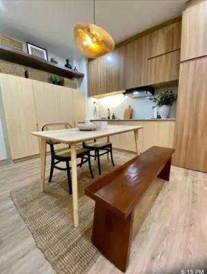 a kitchen with a table and chairs and a dining room at NUVALI Amaia Steps Parkway 2 BR Condo THE SANCTUARY with pool, free parking near Carmelray Industrial Park, Ayala Solenad, Xavier School in Pitland