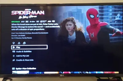 a television screen with a spider man movie on it at Lovely Modern 2BR Condo in Aurora Gardens San Juan City in Manila