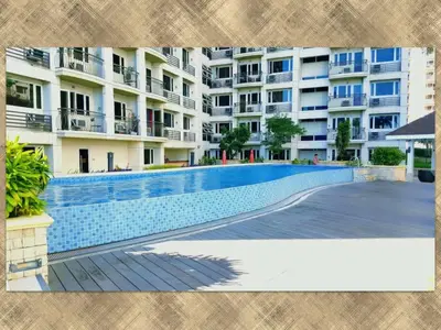 a swimming pool in front of a building at 1BR Solemare Aseana MOA Okada Ayala Bay Mall COD Paranaque w/WIFI in Manila
