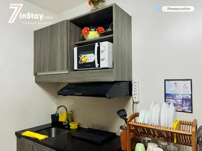 a kitchen with a sink and a microwave at 1BR Solemare Aseana MOA Okada Ayala Bay Mall COD Paranaque w/WIFI in Manila