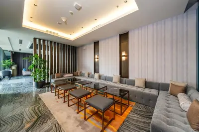 a lobby with a couch and tables and chairs at Seda Manila Bay near Ayala Malls in Manila