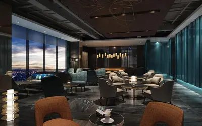 a hotel lobby with chairs and tables and windows at Seda Manila Bay near Ayala Malls in Manila