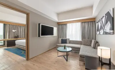 a living room with a couch and a tv at Seda Manila Bay near Ayala Malls in Manila