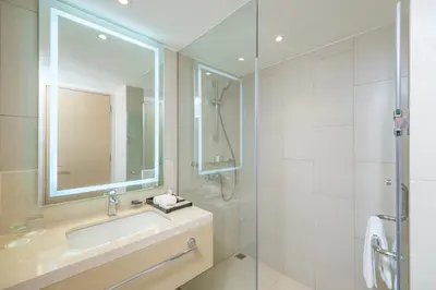 a bathroom with a sink and a shower at Seda Manila Bay near Ayala Malls in Manila