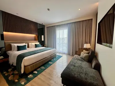 a hotel room with a bed and a couch at Seda Manila Bay near Ayala Malls in Manila