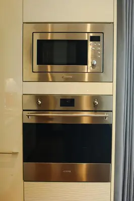 a stainless steel oven with a microwave above it at Poblacion Penthouse Suite with Private Roofdeck in Manila