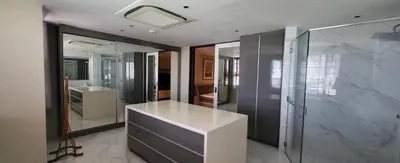 a bathroom with a white counter and a glass shower at Poblacion Penthouse Suite with Private Roofdeck in Manila