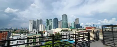 a view of a city skyline with tall buildings at Poblacion Penthouse Suite with Private Roofdeck in Manila