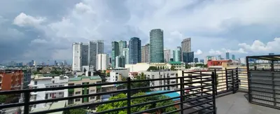 a view of a city skyline with tall buildings at Poblacion Penthouse Suite with Private Roofdeck in Manila