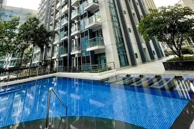 a large blue swimming pool in front of a building at Lovely Unit with free wi-fi & netflix I across Naia T3 airport in Manila