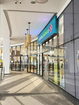 an empty shopping mall with a sign on the wall at Lovely Unit with free wi-fi & netflix I across Naia T3 airport in Manila