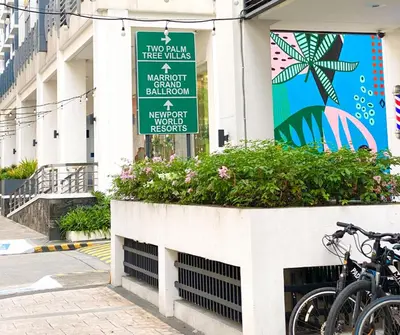 a sign on the side of a building with bikes at Lovely Unit with free wi-fi & netflix I across Naia T3 airport in Manila