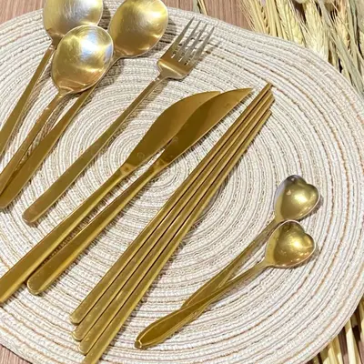 a white plate with gold utensils on a table at Lovely Unit with free wi-fi & netflix I across Naia T3 airport in Manila